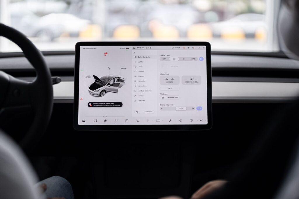 View of a modern car's dashboard featuring a digital display panel with control options.