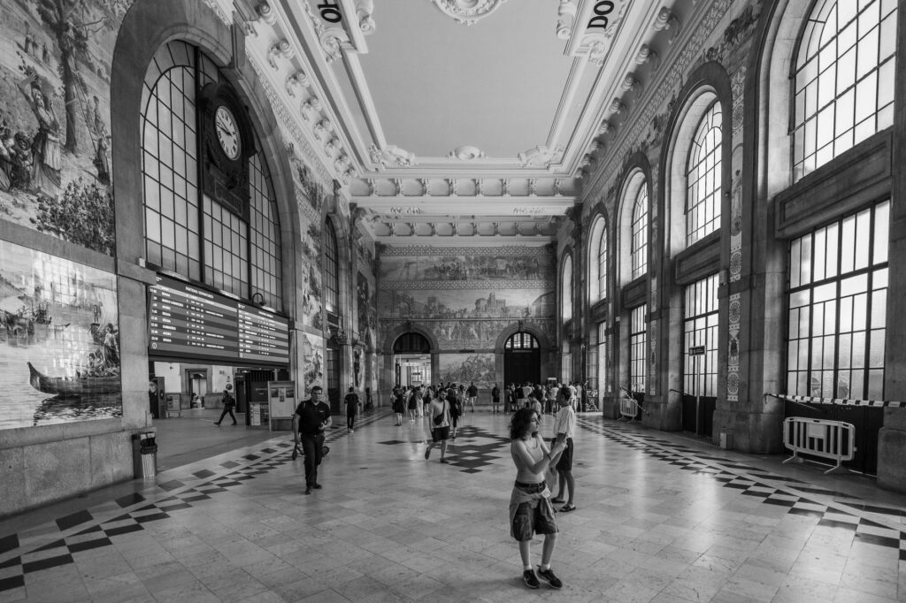 Black and white view of São Bento Station's artistic interior in Porto, Portugal.