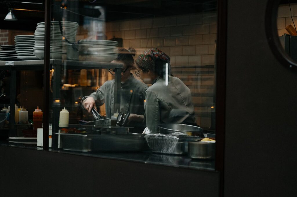 Candid shot of chefs cooking in a restaurant kitchen in Amsterdam.