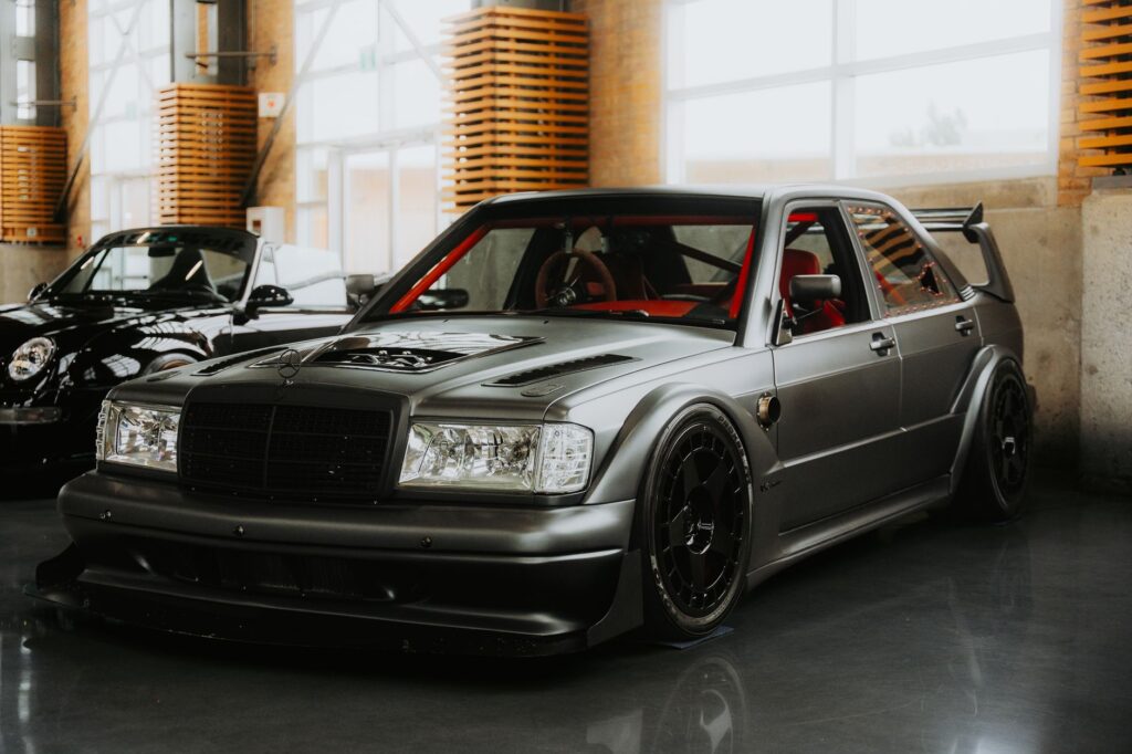 Sleek metallic sports car with modern design inside a well-lit indoor showroom.