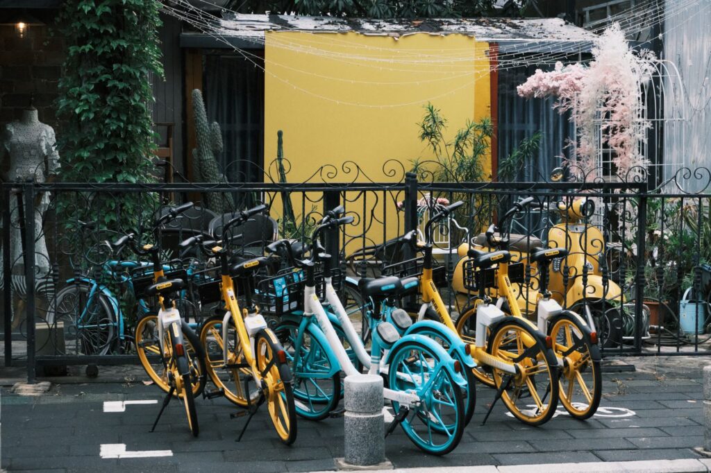 Bicycles parked along a vibrant street in Xiamen, Fujian, China, with a colorful backdrop.
