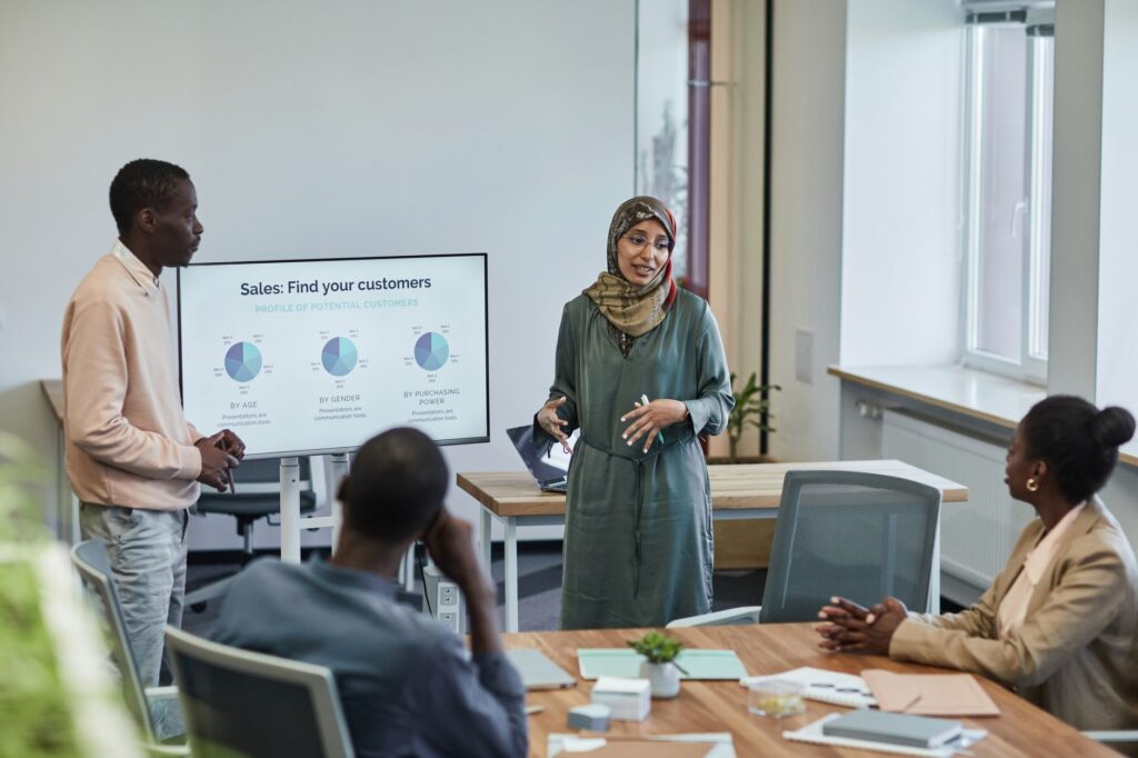 A diverse group of professionals in a business meeting discussing sales strategies.
