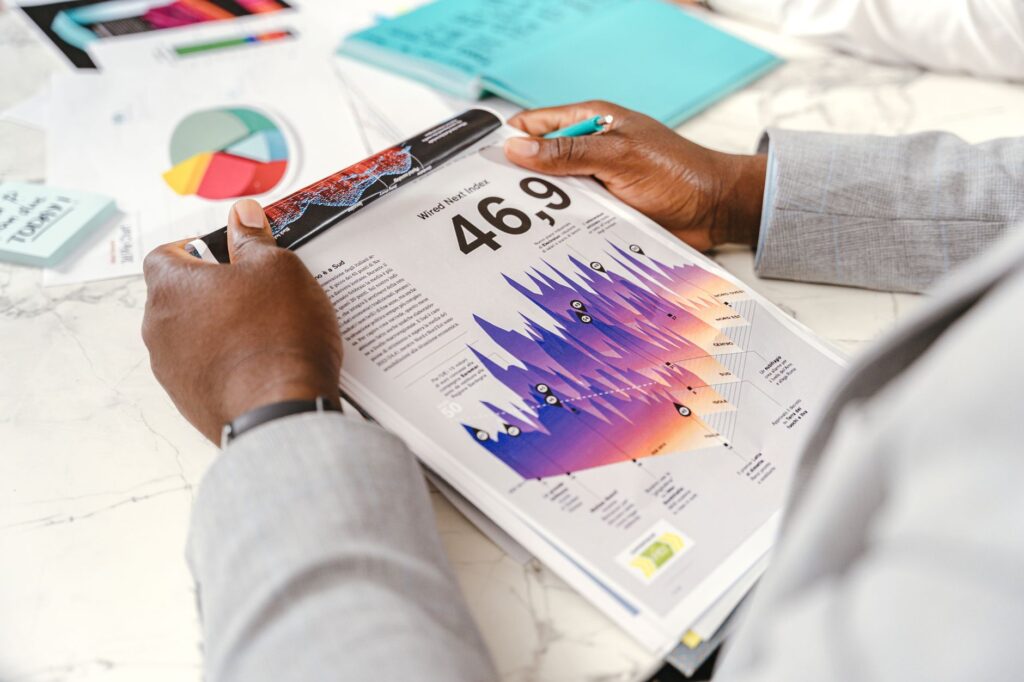 Close-up of a businessman analyzing colorful statistical data in an office setting.
